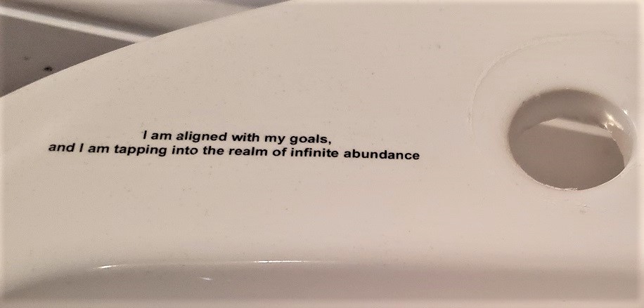 Printed Text or Words On Porcelain Bathroom Sink Closeup