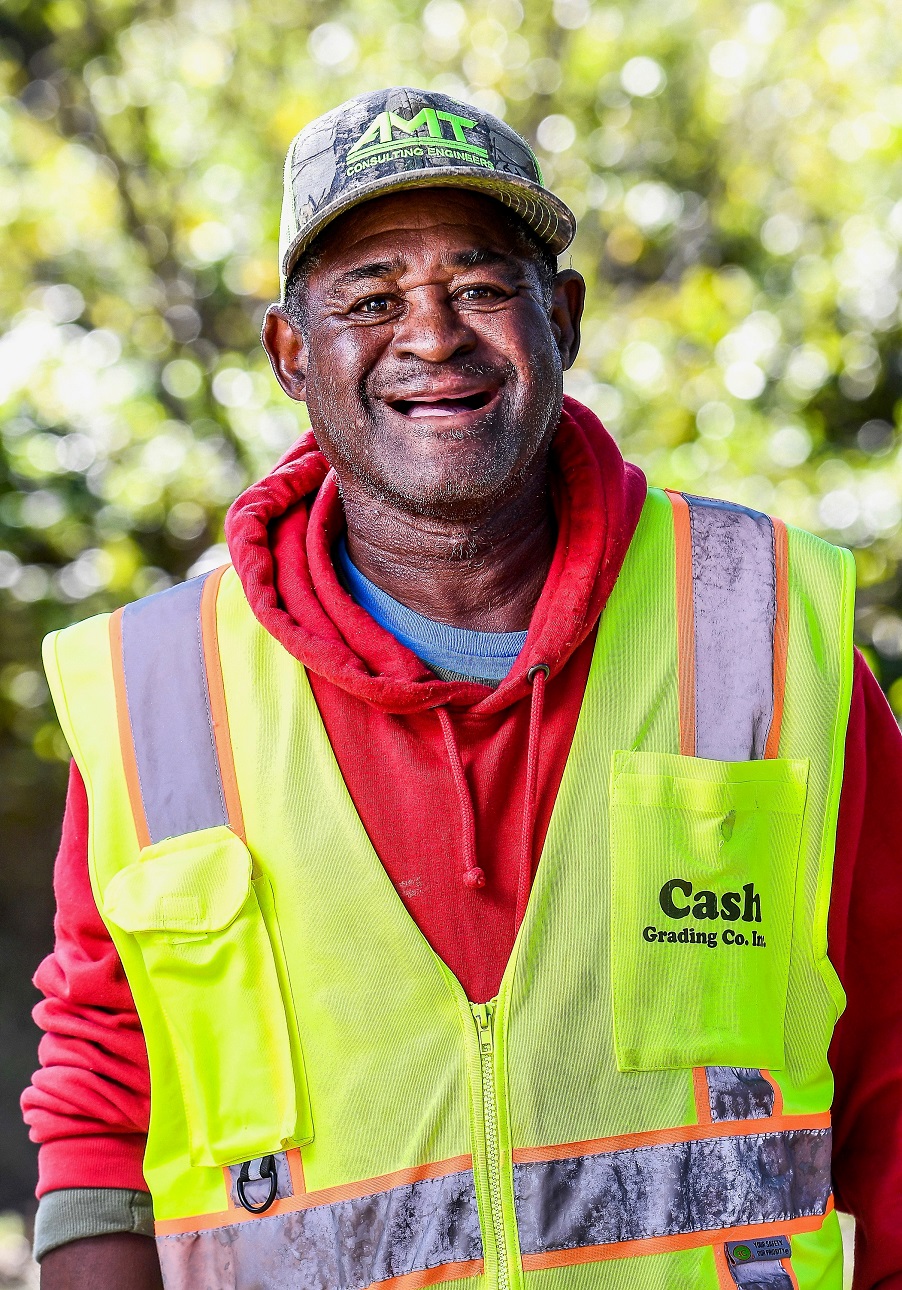 Ted Lilly smiling in a yellow safety vest – original portrait used for his porcelain memorial mural