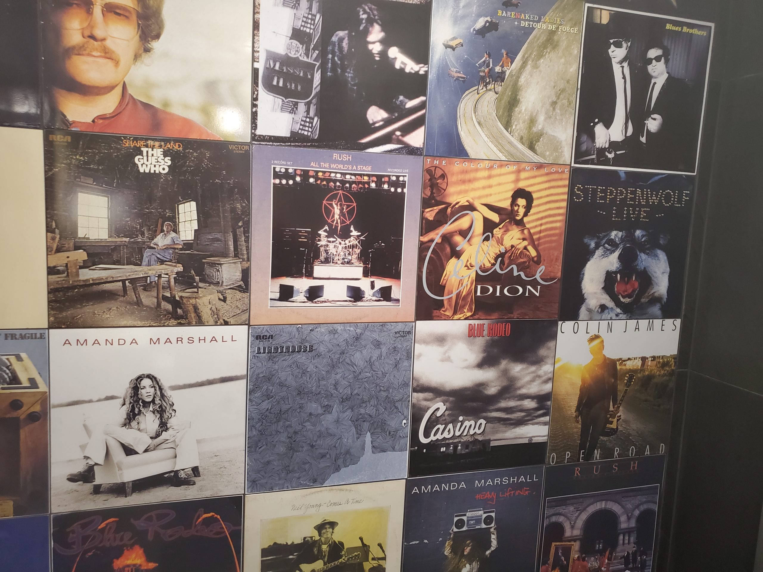 Private music room album cover tiled wall with custom printed porcelain tiles installed vertically