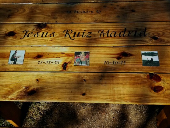 Memorial Picnic Table — Embedded Outdoor Photo Tile Detail Close-up of three square photo tiles inset into an engraved wooden memorial picnic table.
